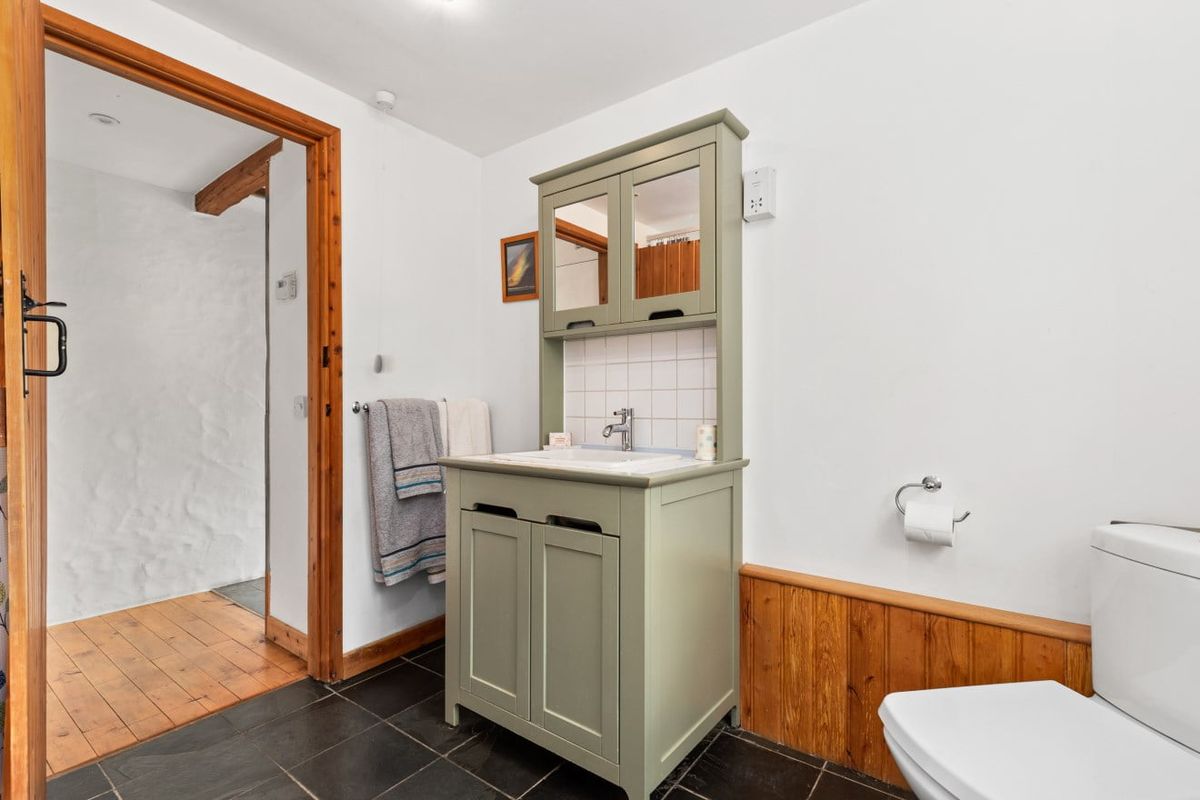 Bathroom with bath, basin unit and window