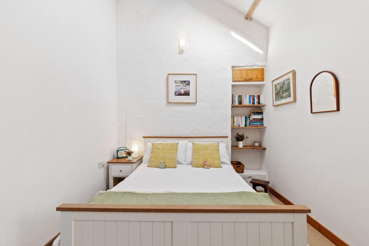 Double bedroom with white walls and a rooflight