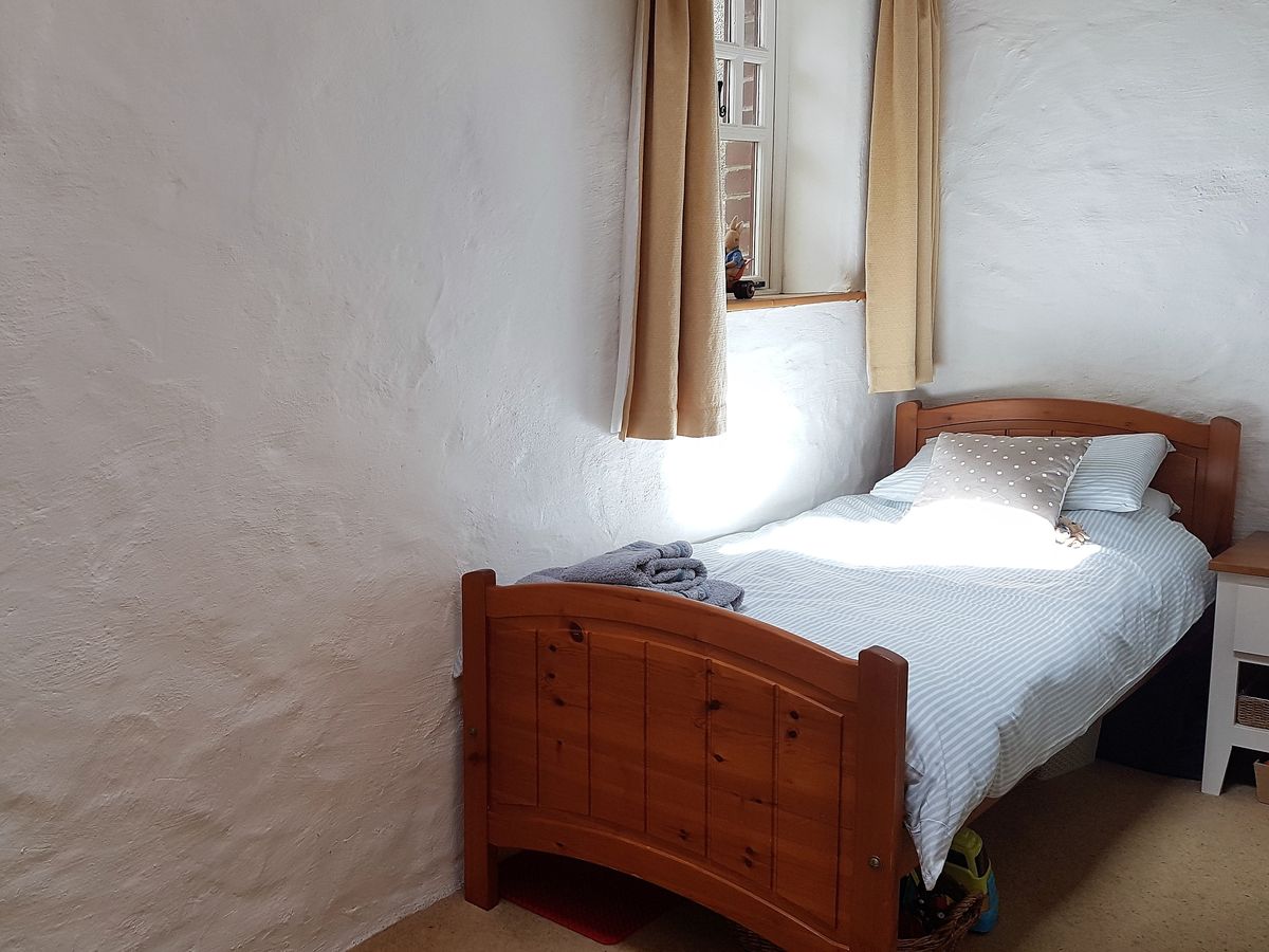 Twin bedroom with a wooden single bed